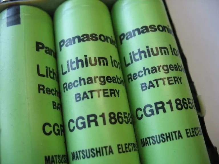 Three cylindrical Panasonic CGR18650 lithium-ion cells.